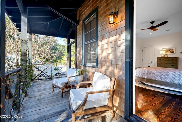 wooden deck with ceiling fan and covered porch