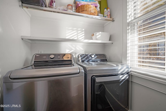 clothes washing area featuring washer and dryer