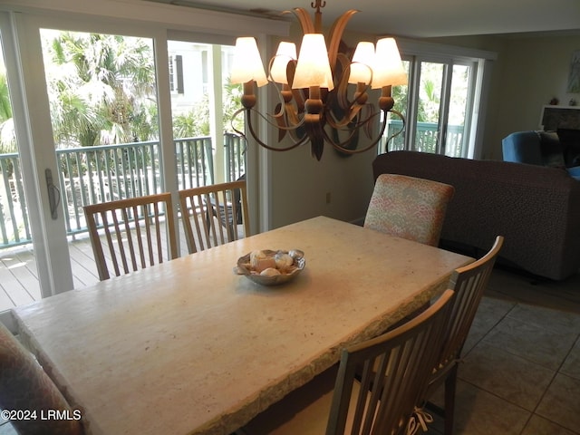 dining room with a notable chandelier and tile patterned floors