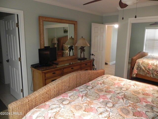 bedroom with ornamental molding and ceiling fan