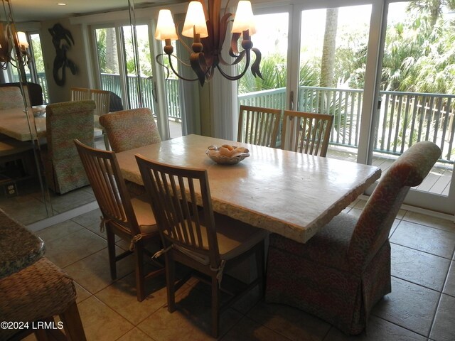 dining space featuring an inviting chandelier, plenty of natural light, and light tile patterned flooring