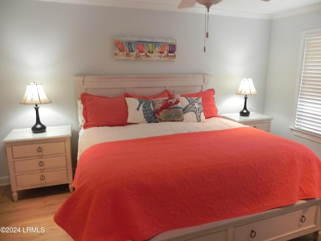 bedroom with crown molding, ceiling fan, and light hardwood / wood-style floors