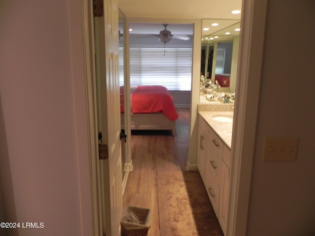 bathroom with ceiling fan, vanity, and hardwood / wood-style floors