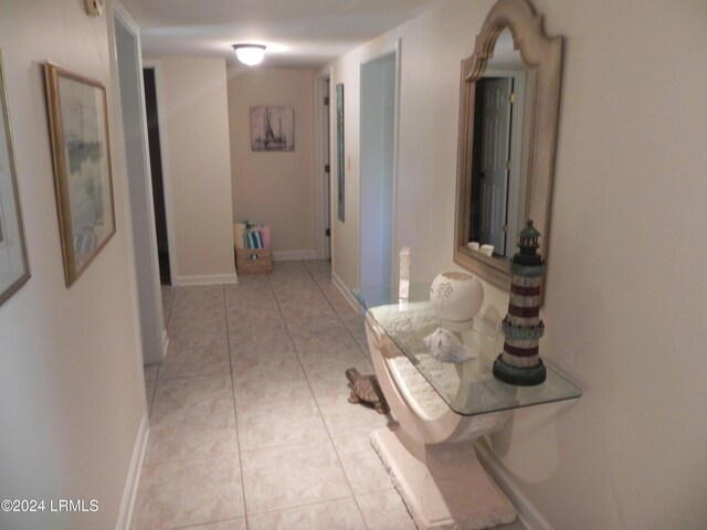 corridor with light tile patterned floors