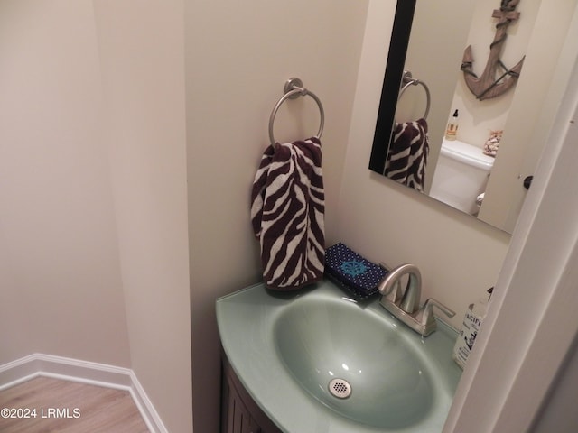 bathroom with sink, hardwood / wood-style floors, and toilet