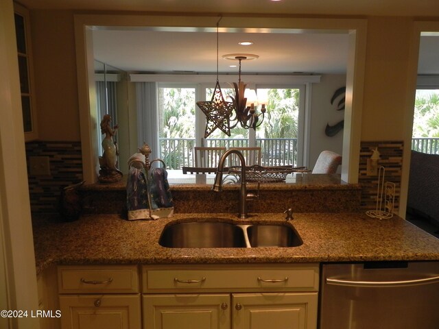 kitchen with a healthy amount of sunlight, dishwasher, sink, and hanging light fixtures