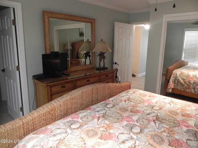 bedroom featuring crown molding and a closet