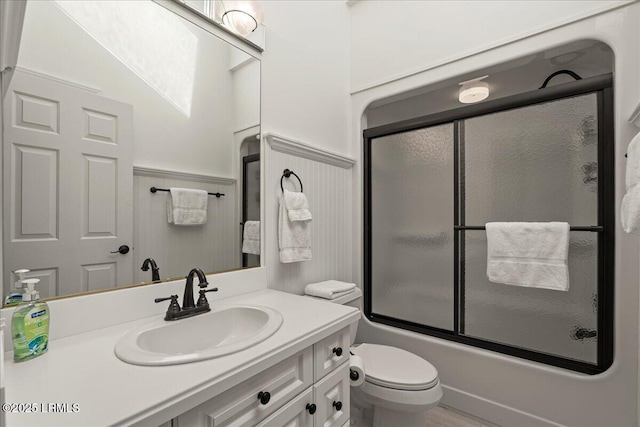 419 Bb Sams Dr, Saint Helena Island, SC 29920 - full bathroom featuring toilet, vanity, combined bath / shower with glass door, and a wainscoted wall