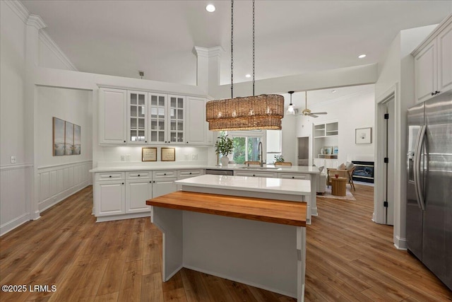 419 Bb Sams Dr, Saint Helena Island, SC 29920 - kitchen with appliances with stainless steel finishes, a sink, wooden counters, ceiling fan, and a peninsula