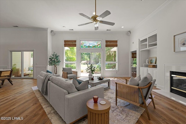 419 Bb Sams Dr, Saint Helena Island, SC 29920 - living area with built in features, plenty of natural light, a ceiling fan, crown molding, and wood finished floors