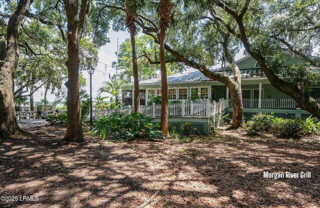 419 Bb Sams Dr, Saint Helena Island, SC 29920 - rear view of house featuring a porch and metal roof