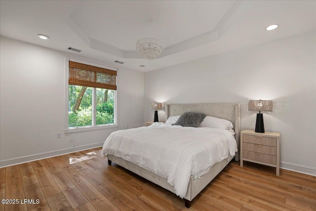 419 Bb Sams Dr, Saint Helena Island, SC 29920 - bedroom with baseboards, light wood-style flooring, a raised ceiling, and recessed lighting