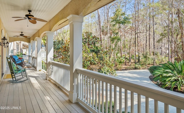 wooden terrace with covered porch and ceiling fan