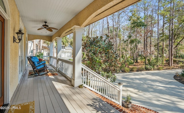 wooden deck featuring ceiling fan and a porch