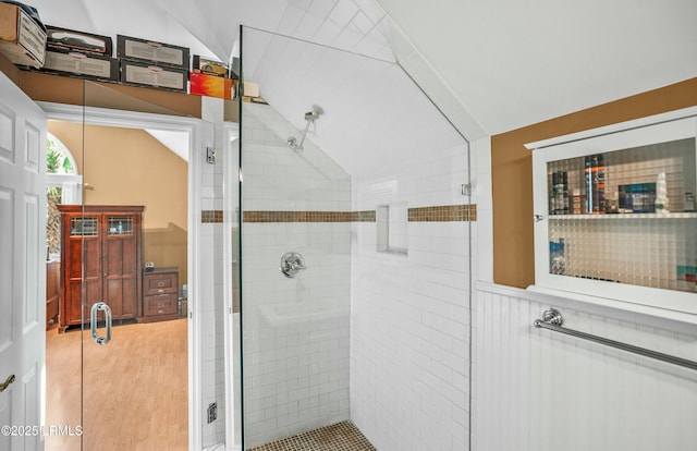 bathroom featuring lofted ceiling and an enclosed shower