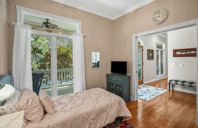 bedroom featuring ornamental molding, access to outside, and hardwood / wood-style floors