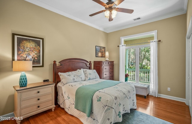 bedroom featuring crown molding, hardwood / wood-style flooring, and ceiling fan