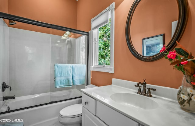 full bathroom with vanity, toilet, and combined bath / shower with glass door