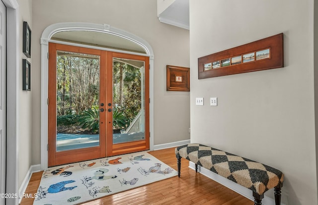 entryway with wood-type flooring and french doors