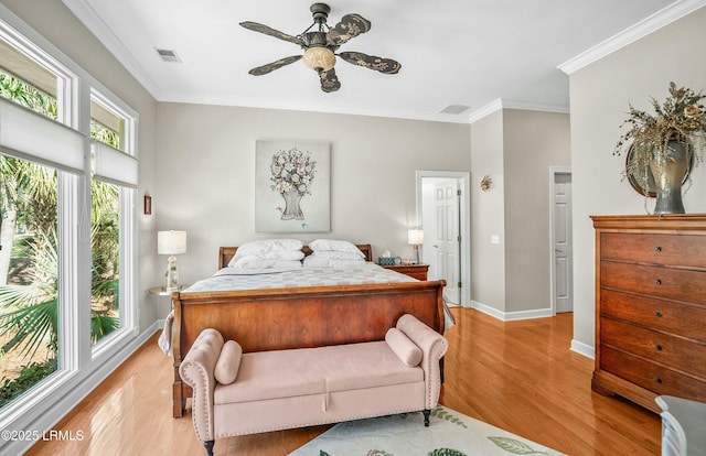 bedroom with ceiling fan, ornamental molding, and light hardwood / wood-style floors