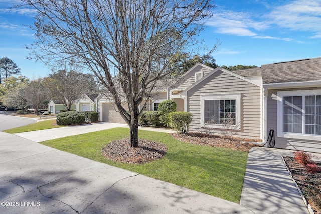 15 Padgett Dr, Bluffton, SC 29909 - view of side of home with a garage and a lawn
