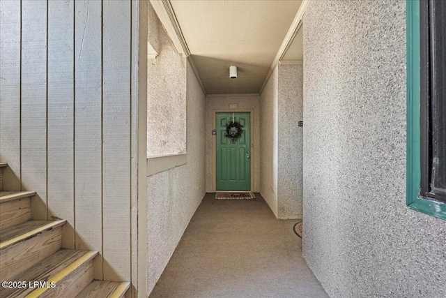 doorway to property featuring stucco siding