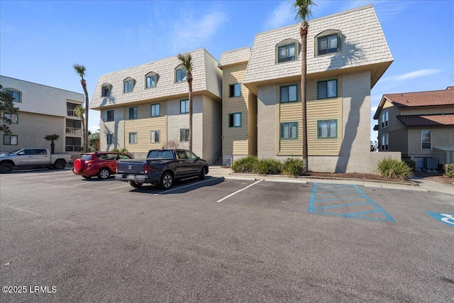 view of property with uncovered parking and a residential view