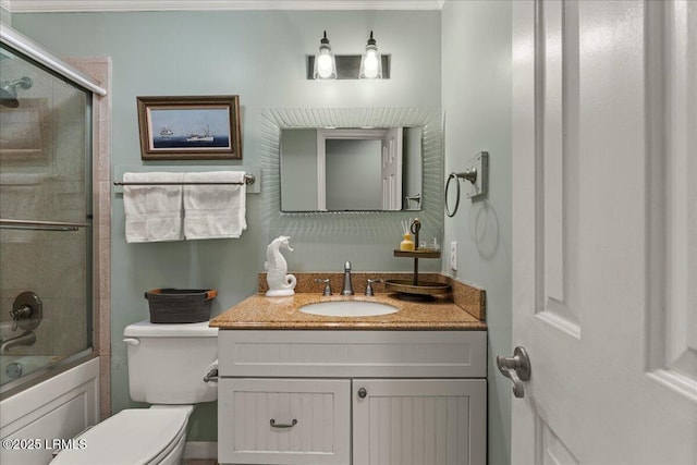 bathroom featuring enclosed tub / shower combo, vanity, and toilet
