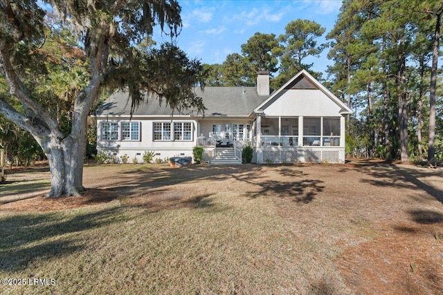 view of front facade featuring a sunroom and a front yard