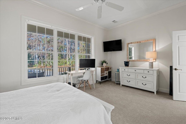 carpeted bedroom featuring crown molding and ceiling fan