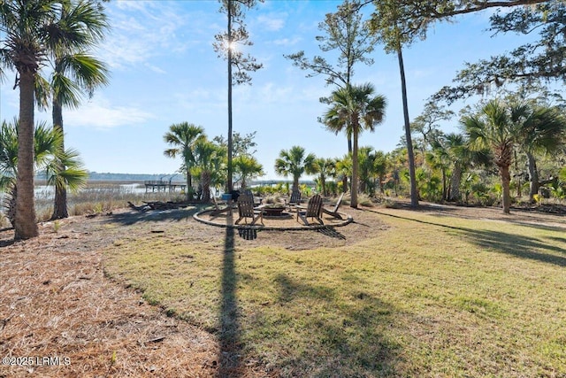 view of yard featuring a water view and a fire pit