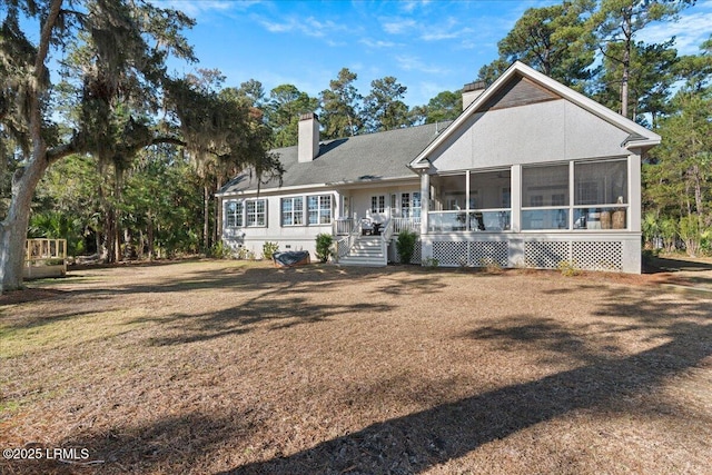 view of front of home with a front lawn and a sunroom