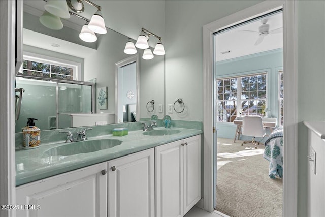 bathroom with vanity, a shower with door, a wealth of natural light, and ornamental molding