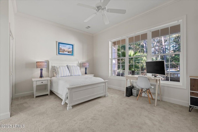 bedroom featuring ornamental molding, light colored carpet, and ceiling fan