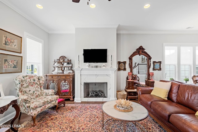 2712 Bluestem Dr, Beaufort, SC 29902 - living room with a ceiling fan, wood finished floors, a fireplace, and crown molding
