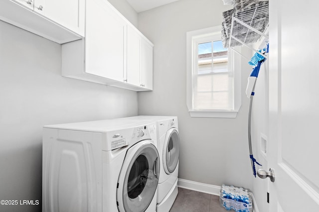 2712 Bluestem Dr, Beaufort, SC 29902 - clothes washing area featuring washing machine and dryer, dark tile patterned flooring, baseboards, and cabinet space