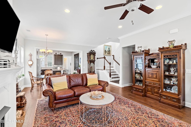 2712 Bluestem Dr, Beaufort, SC 29902 - living room with hardwood / wood-style flooring, crown molding, stairs, and ceiling fan with notable chandelier