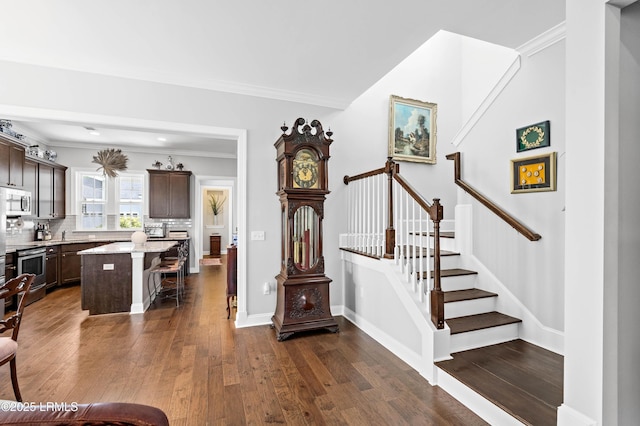 2712 Bluestem Dr, Beaufort, SC 29902 - stairway featuring baseboards, ornamental molding, and hardwood / wood-style floors
