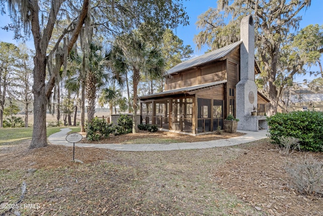 2712 Bluestem Dr, Beaufort, SC 29902 - exterior space with a chimney, a sunroom, and metal roof