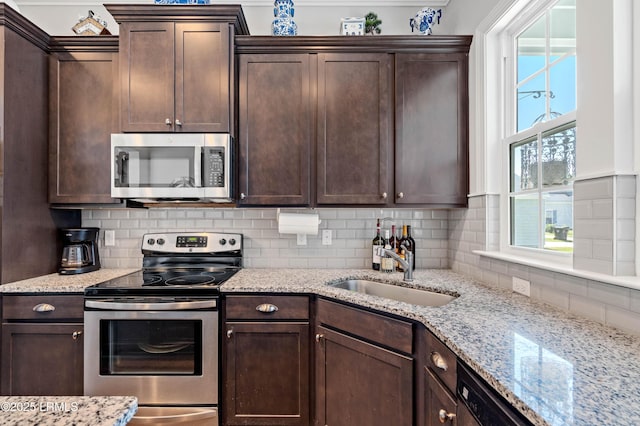 2712 Bluestem Dr, Beaufort, SC 29902 - kitchen with dark brown cabinetry, stainless steel appliances, and a sink
