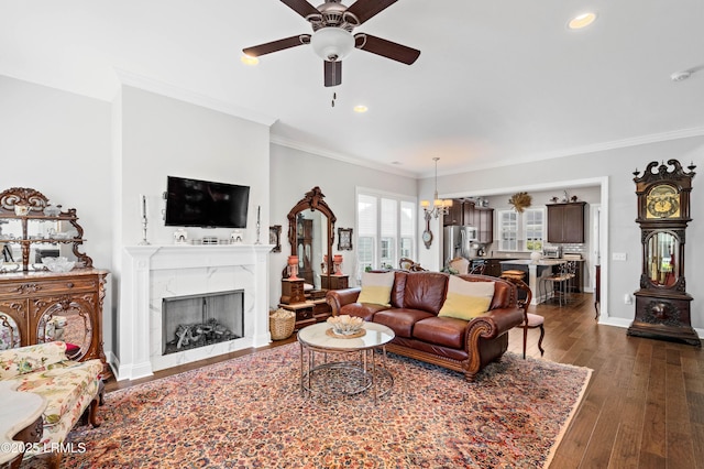 2712 Bluestem Dr, Beaufort, SC 29902 - living area featuring recessed lighting, dark wood finished floors, crown molding, a fireplace, and ceiling fan