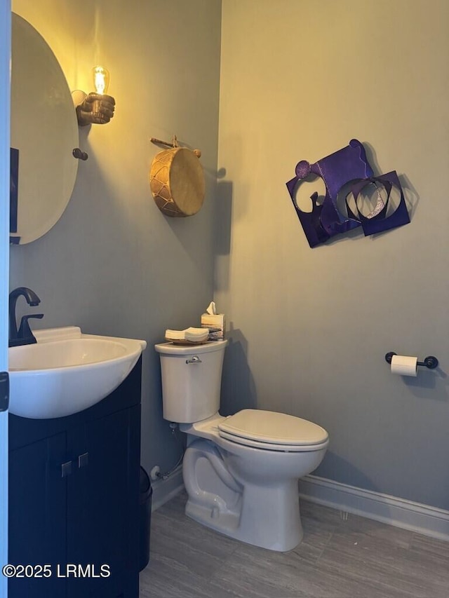 1118 Otter Cir, Beaufort, SC 29902 - half bathroom with vanity, baseboards, toilet, and wood finished floors