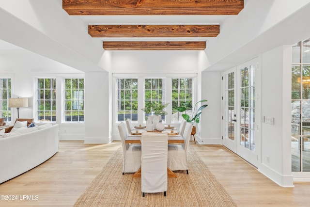 sunroom / solarium featuring beamed ceiling, plenty of natural light, and french doors