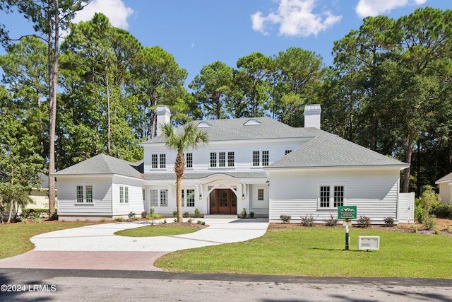 view of front of house featuring french doors and a front lawn