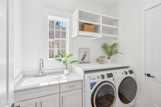 laundry area featuring cabinets, plenty of natural light, sink, and independent washer and dryer