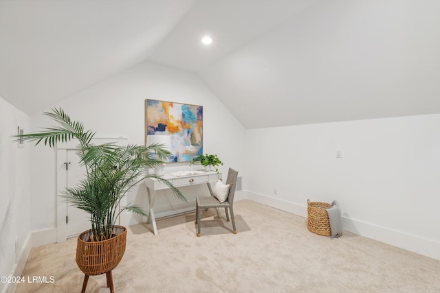 carpeted office with lofted ceiling