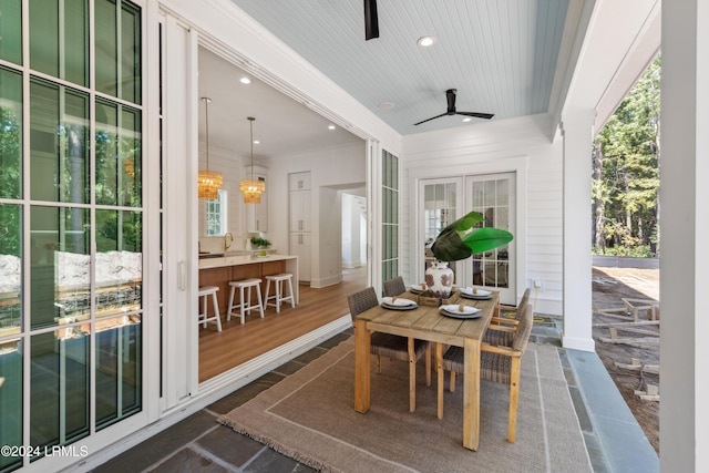 sunroom with sink, wooden ceiling, and ceiling fan