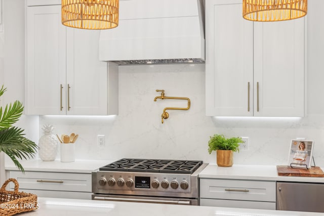 kitchen with white cabinetry, premium range hood, stainless steel gas range, and backsplash