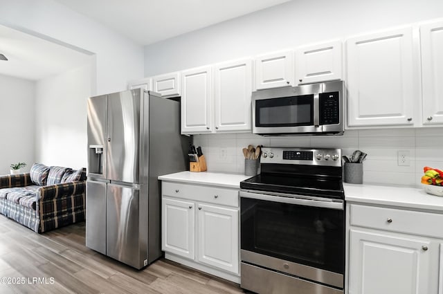 1 Broadland Cir, Bluffton, SC 29910 - kitchen featuring stainless steel appliances, backsplash, white cabinetry, and light wood-style flooring