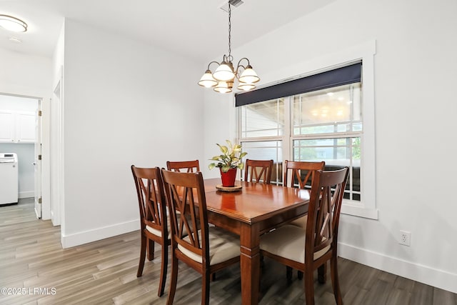 1 Broadland Cir, Bluffton, SC 29910 - dining room with light wood-type flooring, a chandelier, and washer / dryer